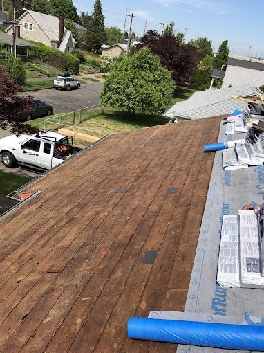 A white truck is parked on the roof of a house.
