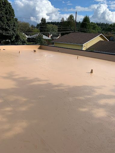A roof with a lot of trees in the background and a house in the background.