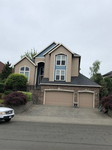 A large house with a car parked in front of it.
