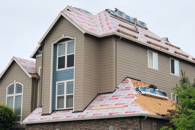 A large house with a roof that is being installed.