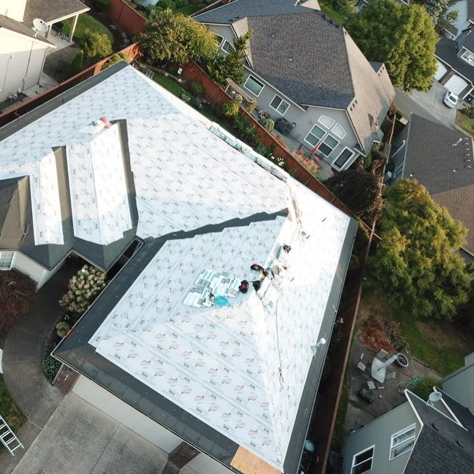 An aerial view of a roof being installed on a house.