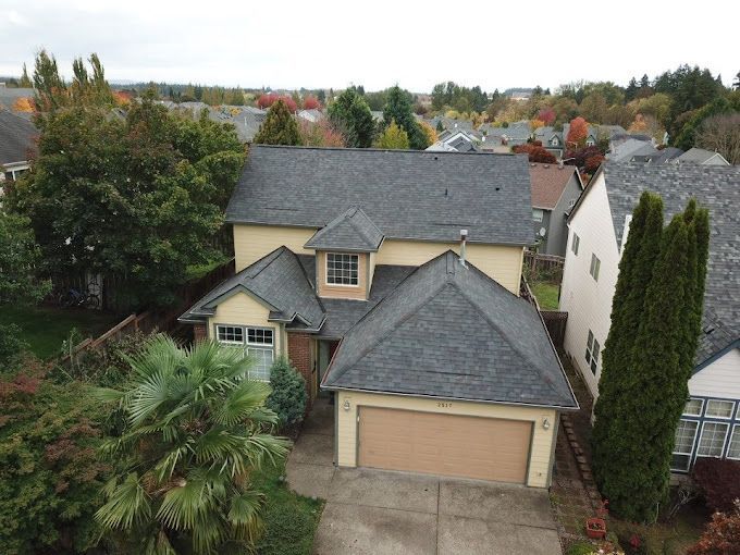 An aerial view of a house with a gray roof.