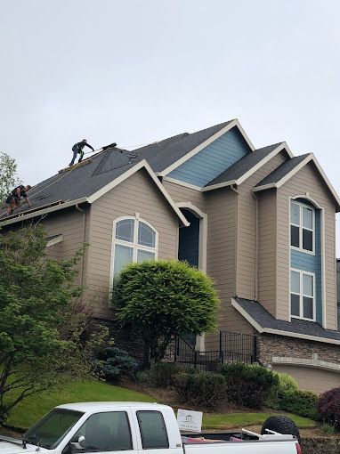 A large house with a white truck parked in front of it.