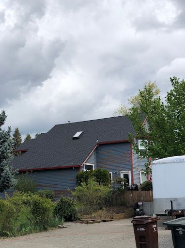 A house with a roof that has a skylight on it.