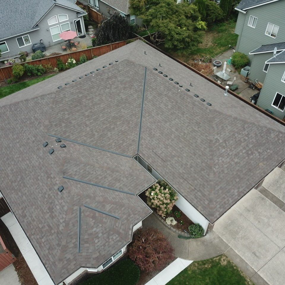 An aerial view of a house with a gray roof.