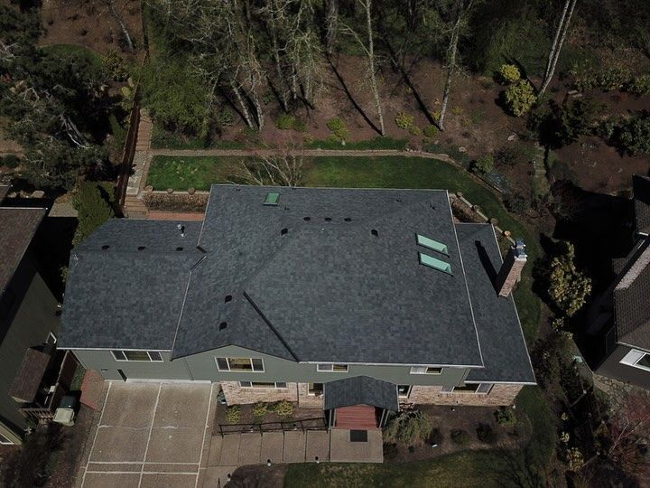 An aerial view of a house with a new roof.