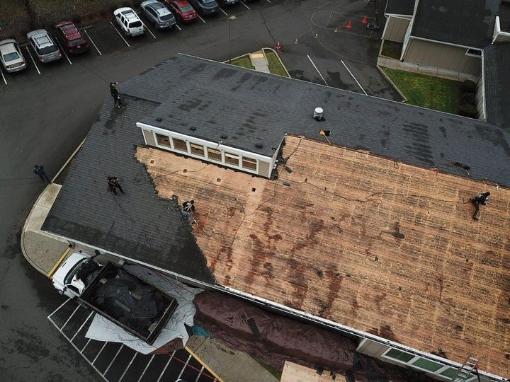 An aerial view of a building with a truck parked in front of it.