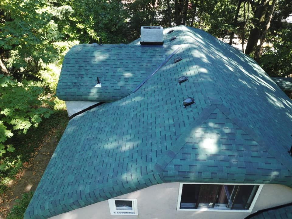 An aerial view of a house with a green roof.