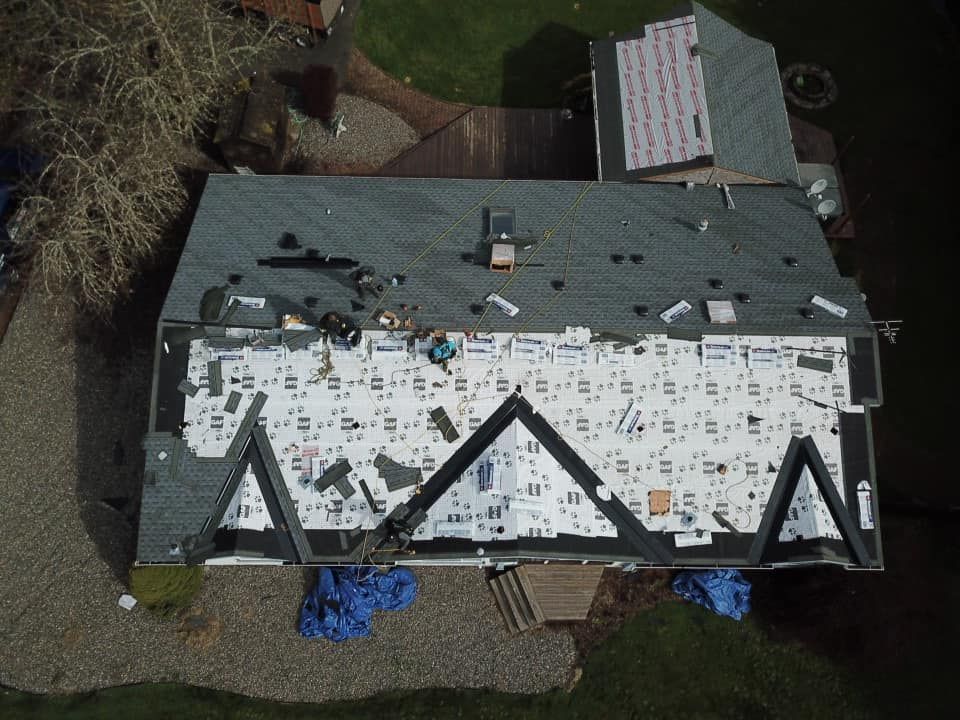 An aerial view of a roof that is being repaired.
