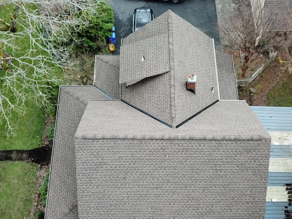 An aerial view of a roof of a house with a chimney.