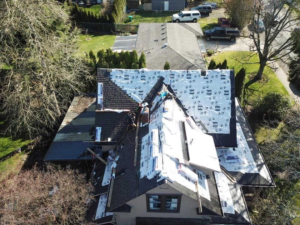 An aerial view of a house with a roof being installed.