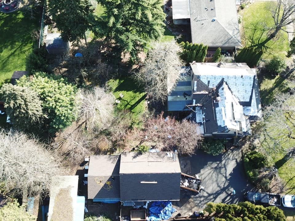 An aerial view of a residential area with houses and trees.