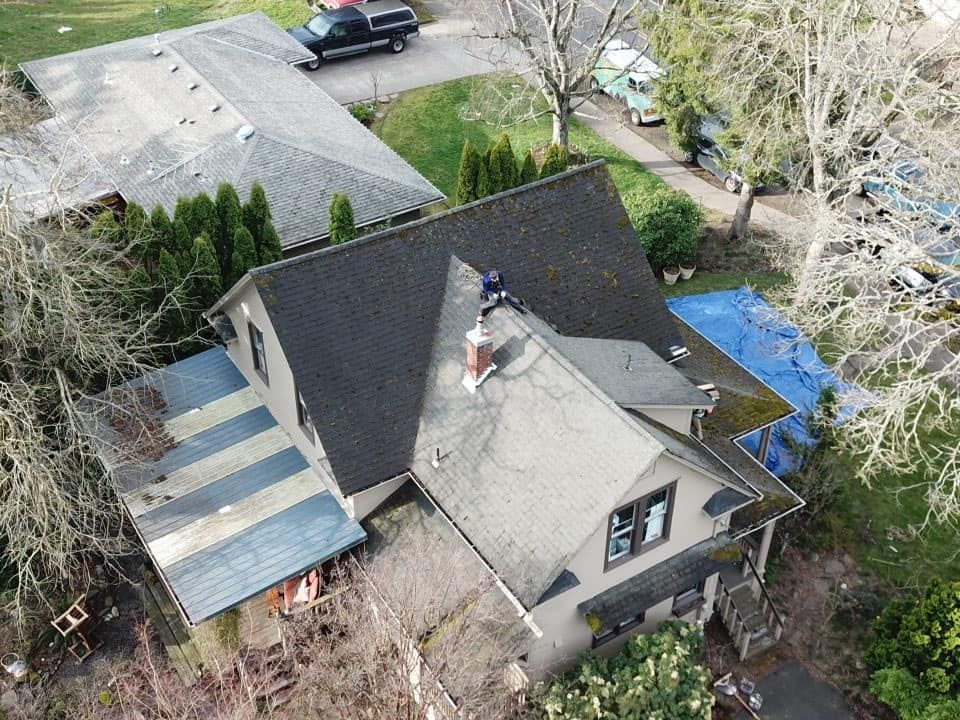 An aerial view of a house with a truck parked in the driveway.