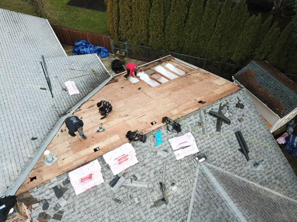 An aerial view of a roof being repaired by a roofer.