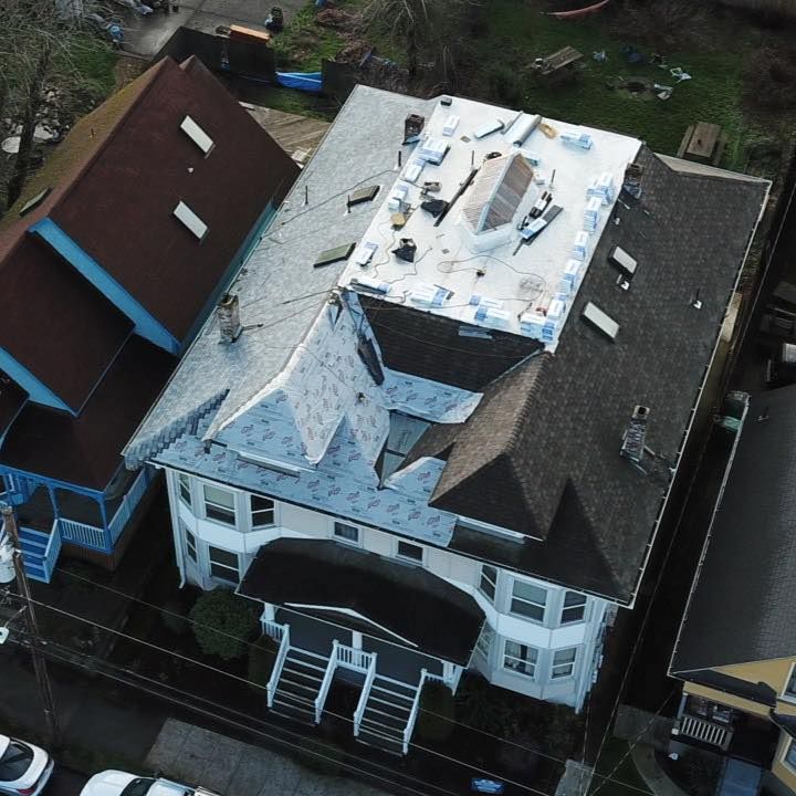 An aerial view of a house with a white roof.