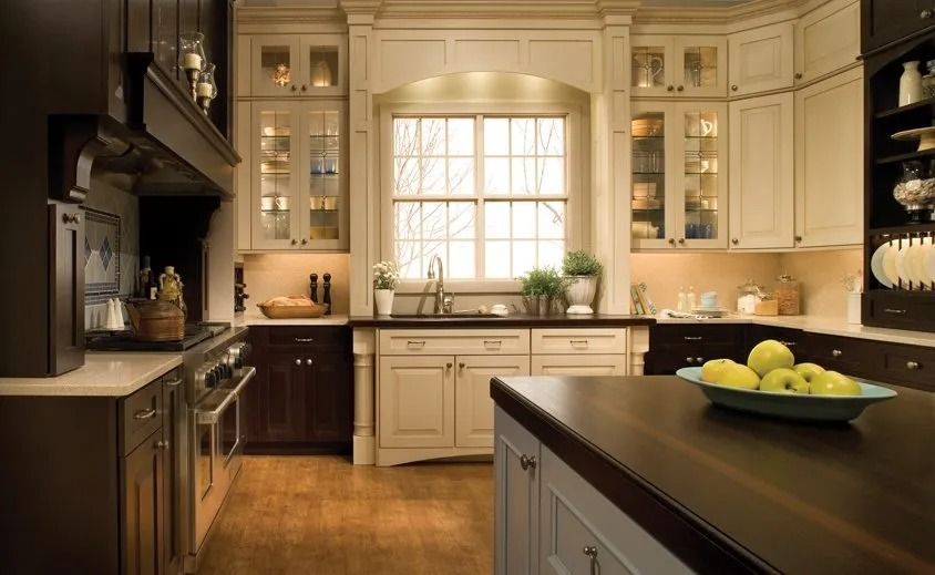 Warm beige kitchen with island, window over sink, and bowl of lemons on the counter