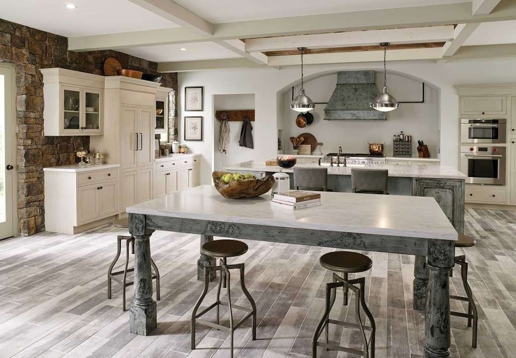 Spacious modern kitchen with a large island, bar stools, and white cabinetry