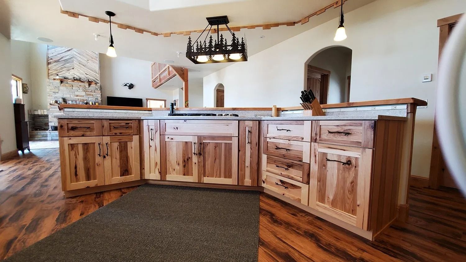 Wooden kitchen island with granite countertop in a rustic home interior