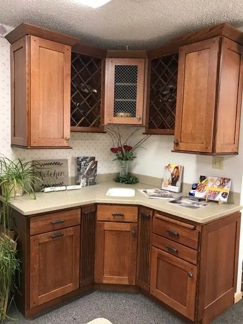 Corner kitchen with wood cabinets, beige countertops, and wine rack shelving