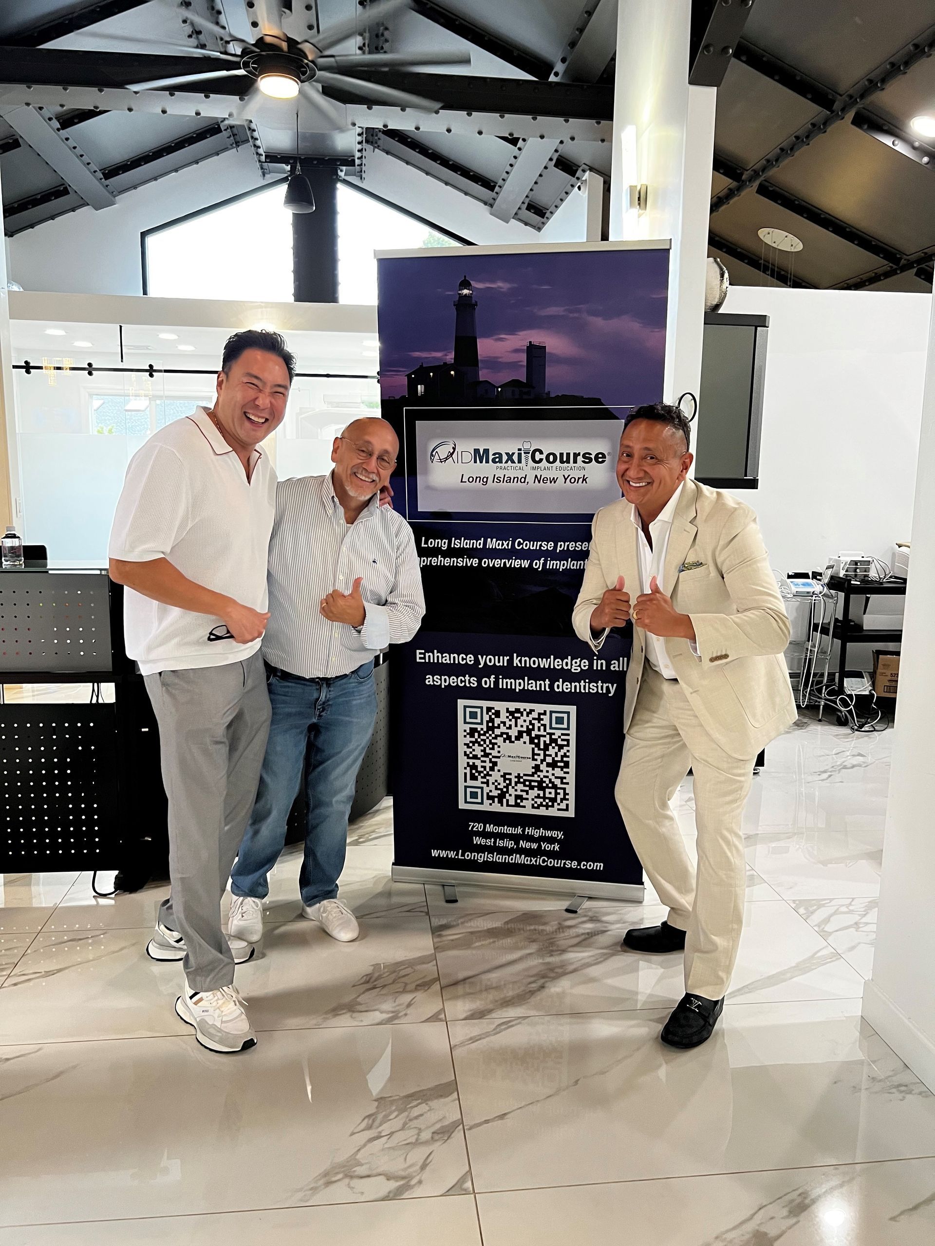 three men are posing for a picture in front of a sign that says qr code