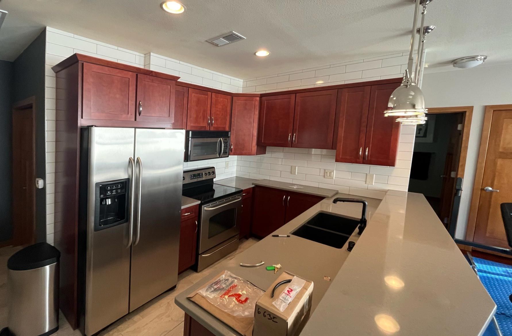 A kitchen with stainless steel appliances and wooden cabinets.