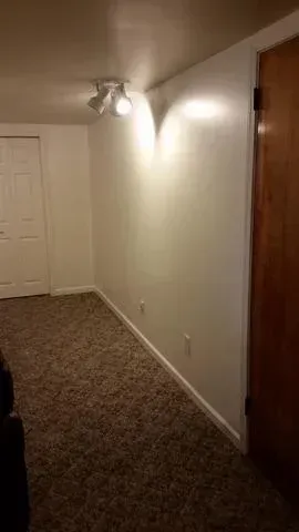 a room with a carpeted floor and bright lights