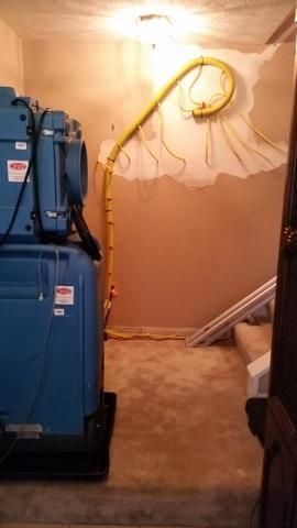 a blue machine is sitting in a room next to a door