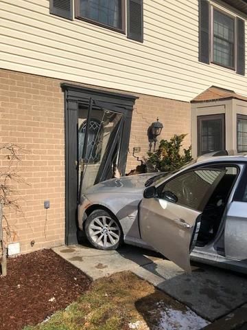 a car has crashed into the front door of a house