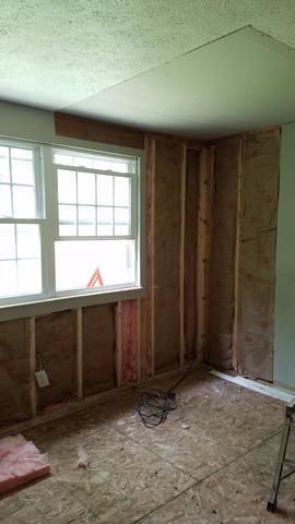 a room with a window and a ladder in it