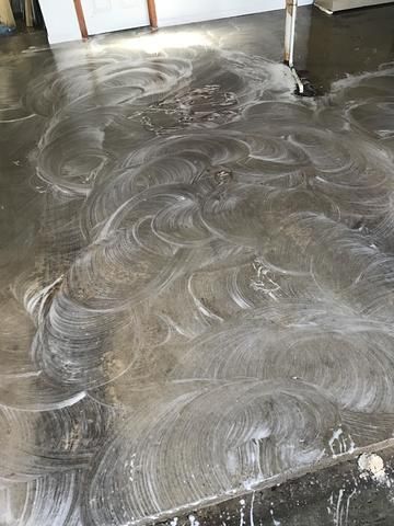 a stainless steel floor with a lot of soap on it