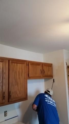 a man in a blue shirt is working in a kitchen