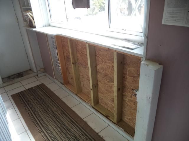 a room with a window and a rug on the floor