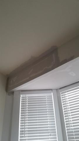 a window with blinds and a ceiling in a room