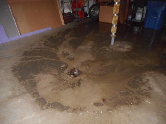 a flooded basement with a lot of mud on the floor