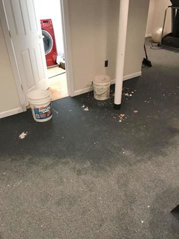 A room damaged by water with a dirty carpet