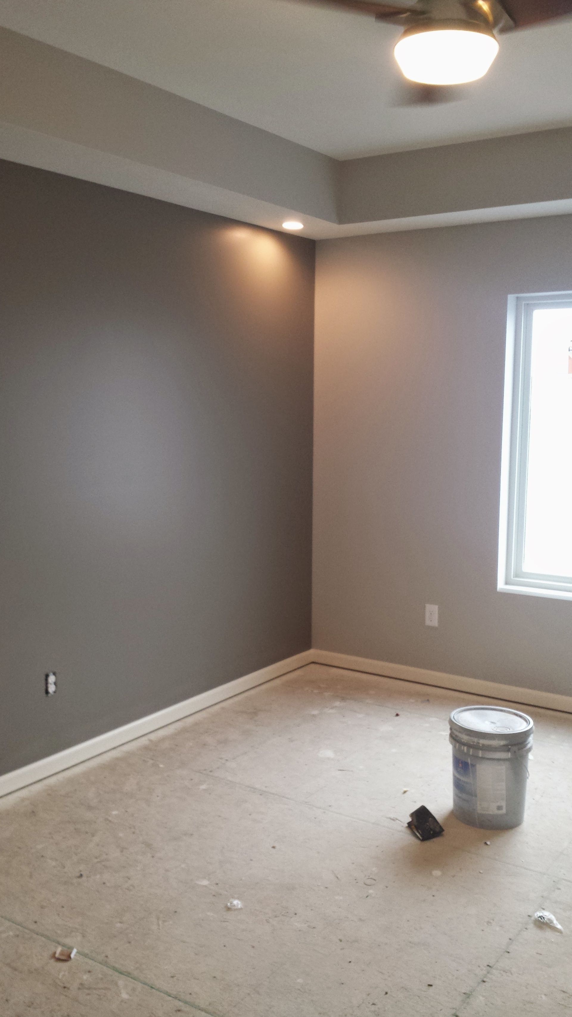 There is a bucket of paint in the middle of the room.