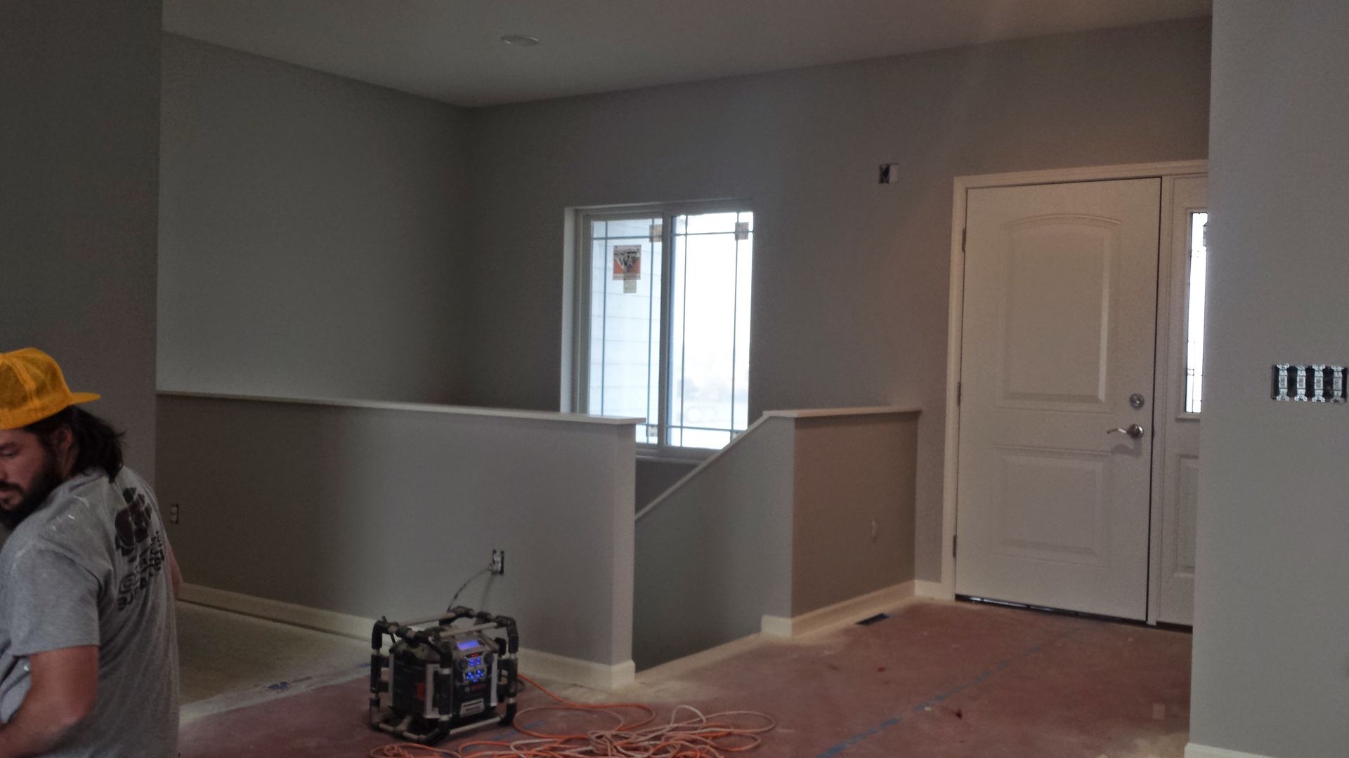 A man is standing in an empty room in a house.