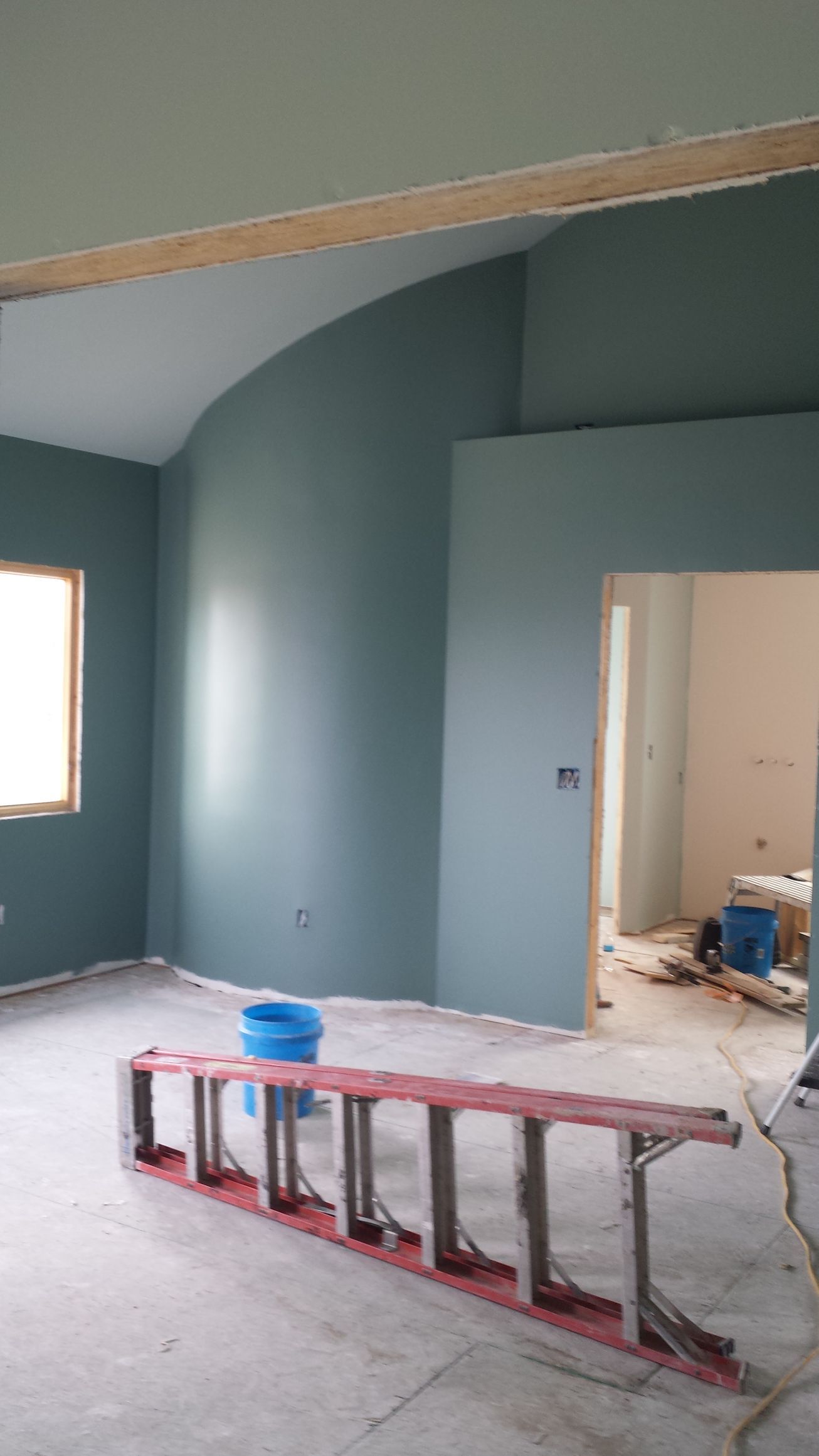 A ladder is sitting in the middle of a room.