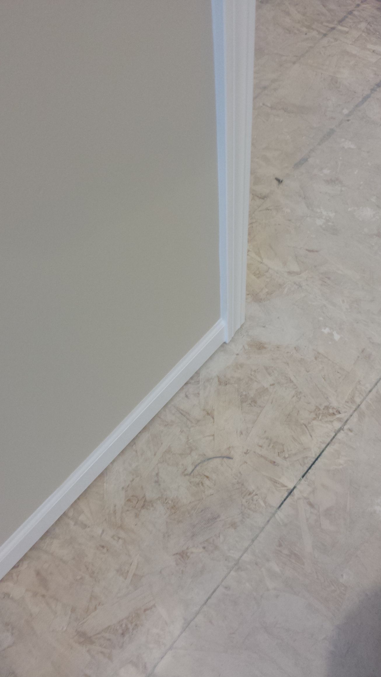 A close up of a tile floor next to a wall.