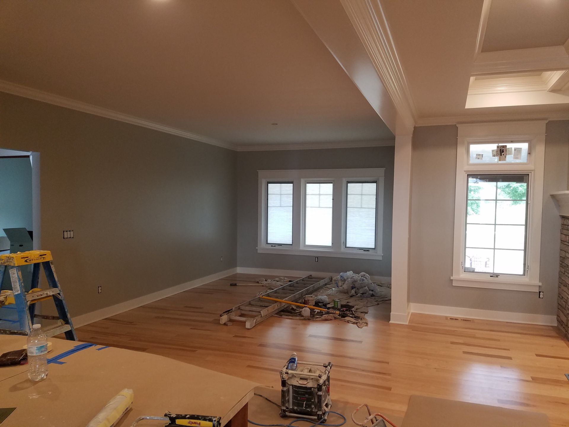 A living room is being painted in a house.