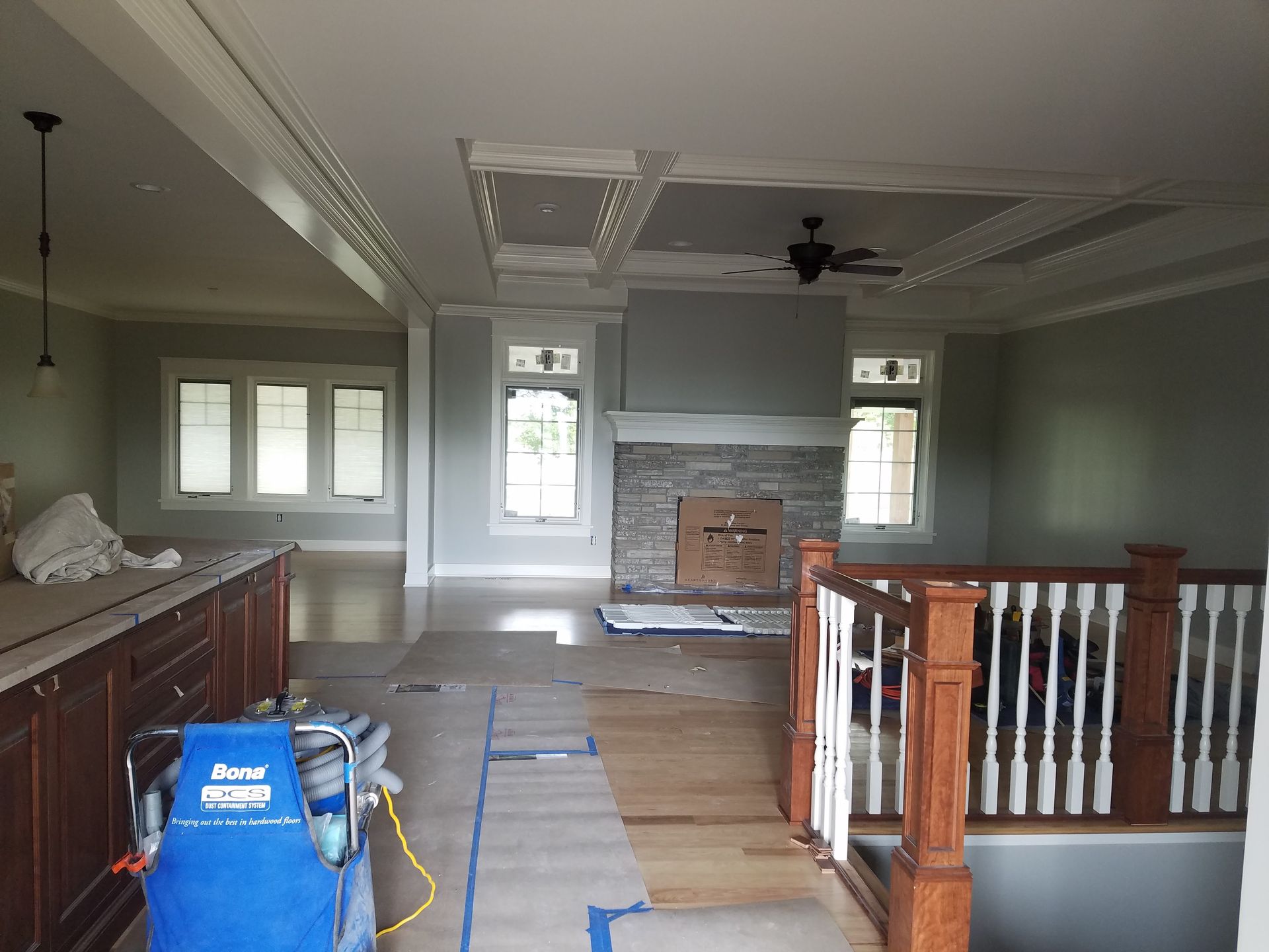 A large living room with a fireplace and a staircase