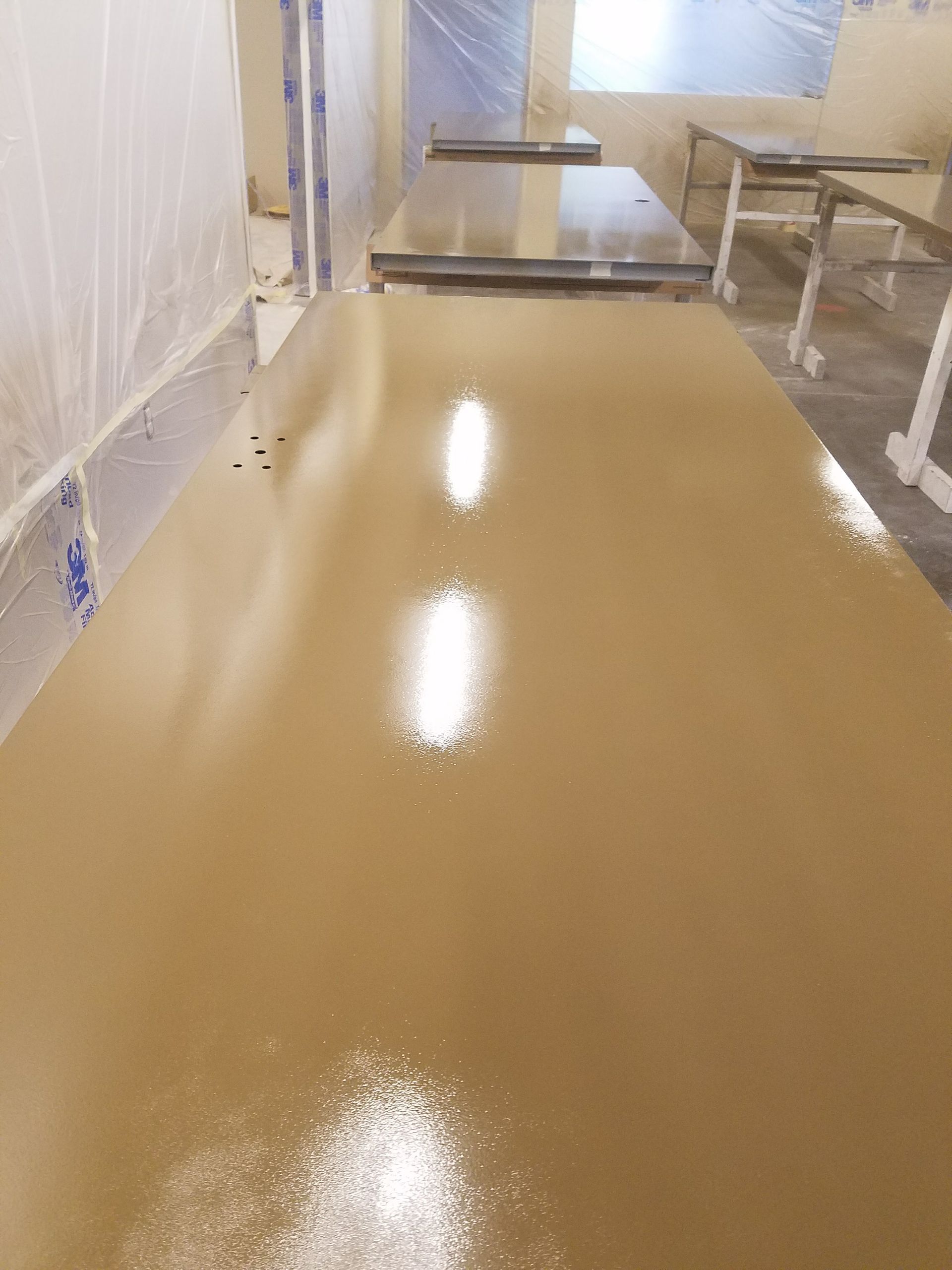 A long table in a room with a lot of tables and chairs.