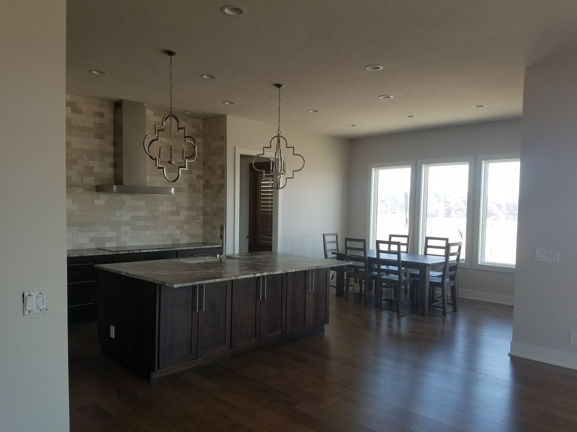 A kitchen with a large island and a dining table