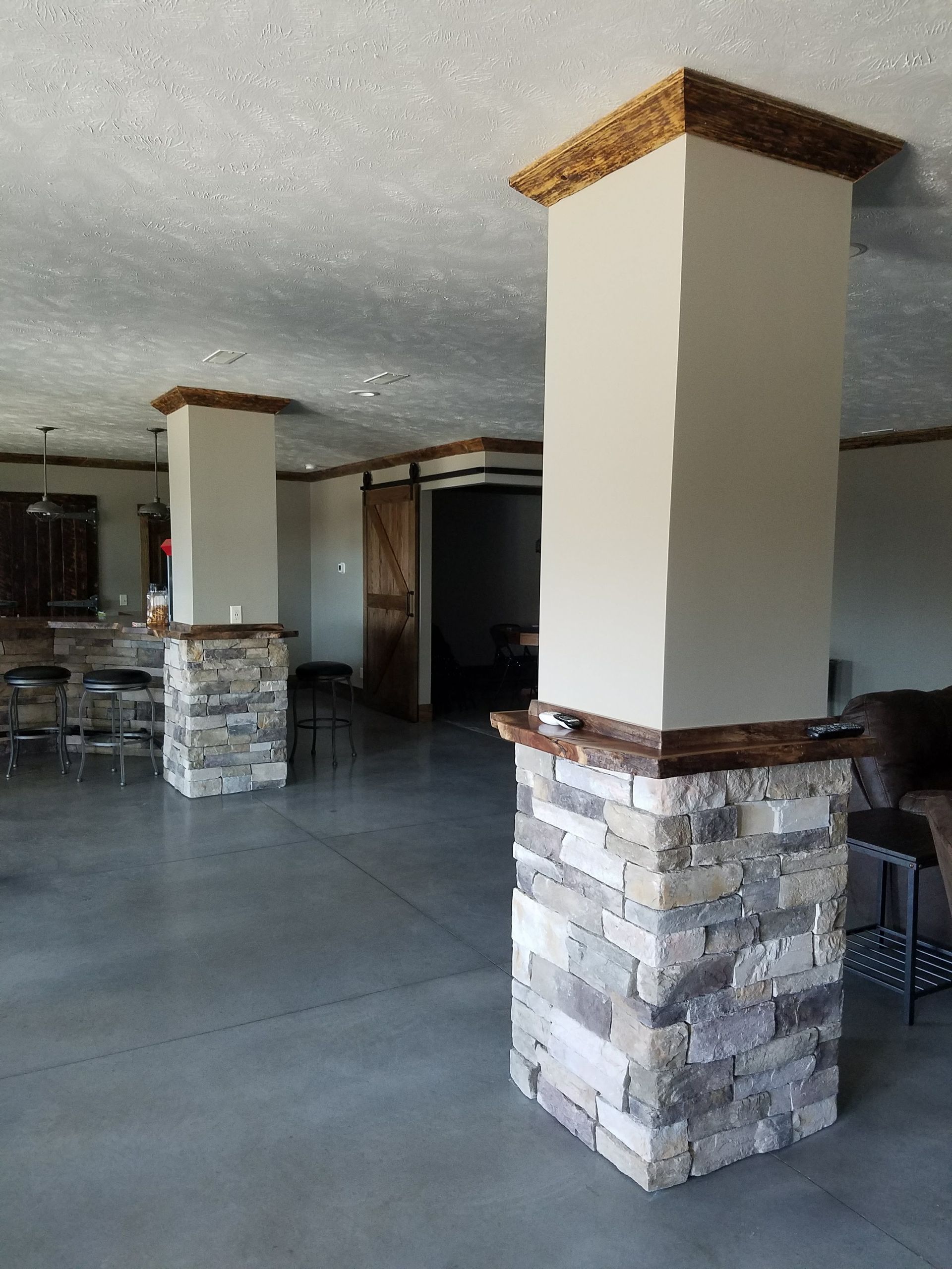 A large room with columns and a concrete floor