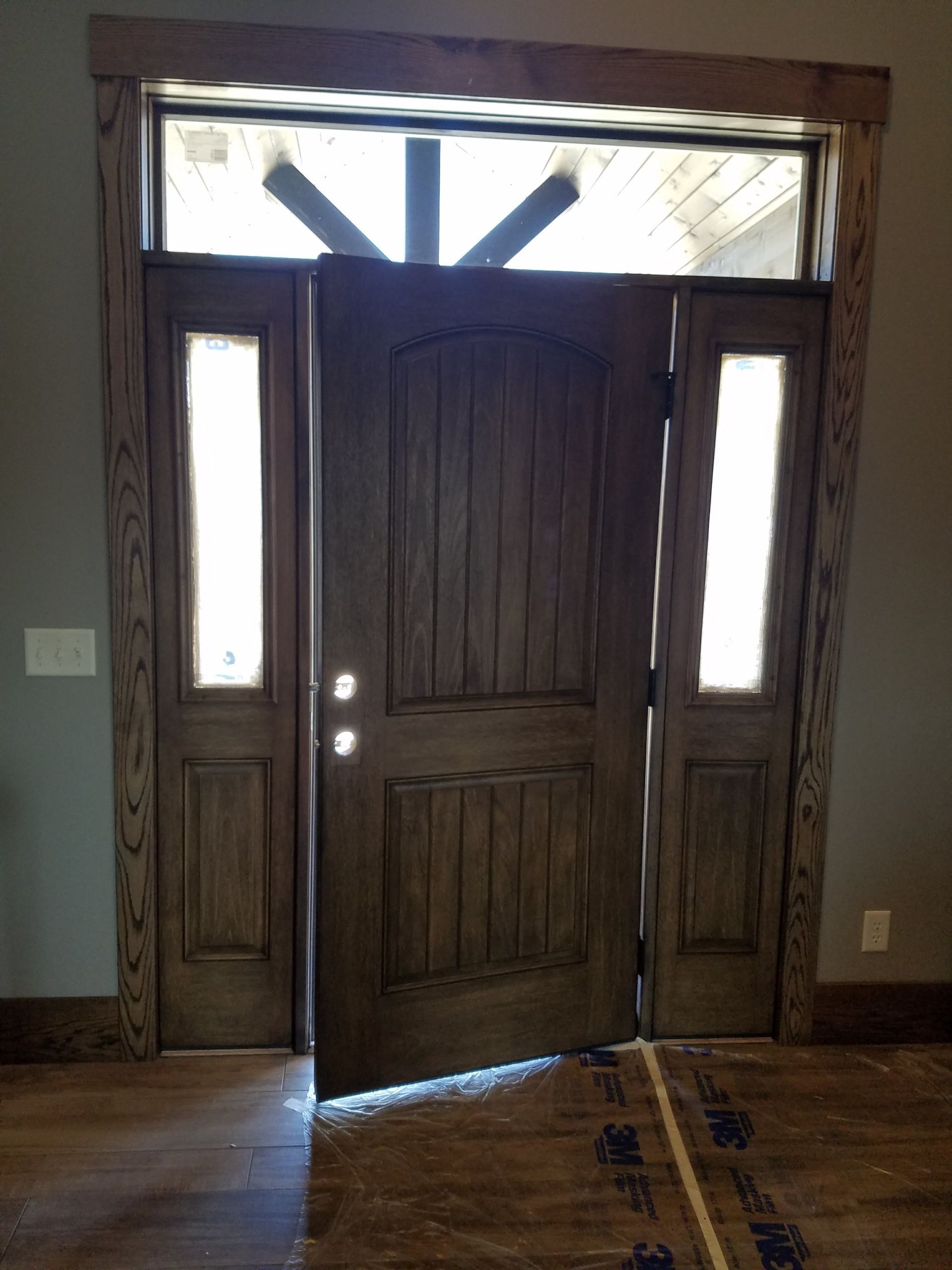A wooden door is open in a room