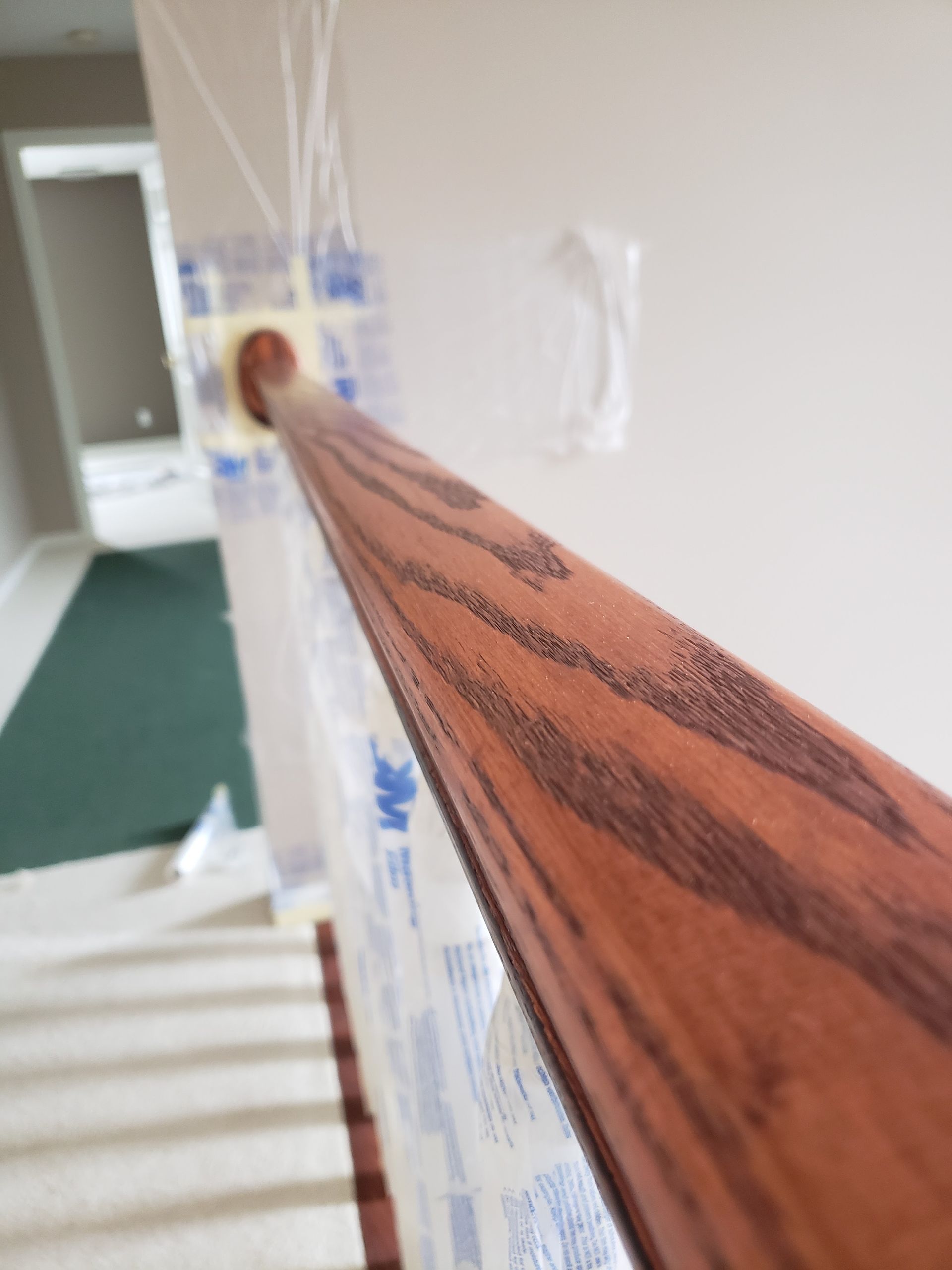 A close up of a wooden railing on a staircase