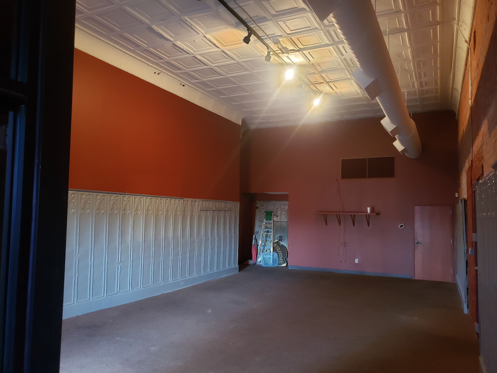 A large empty room with red walls and a white ceiling