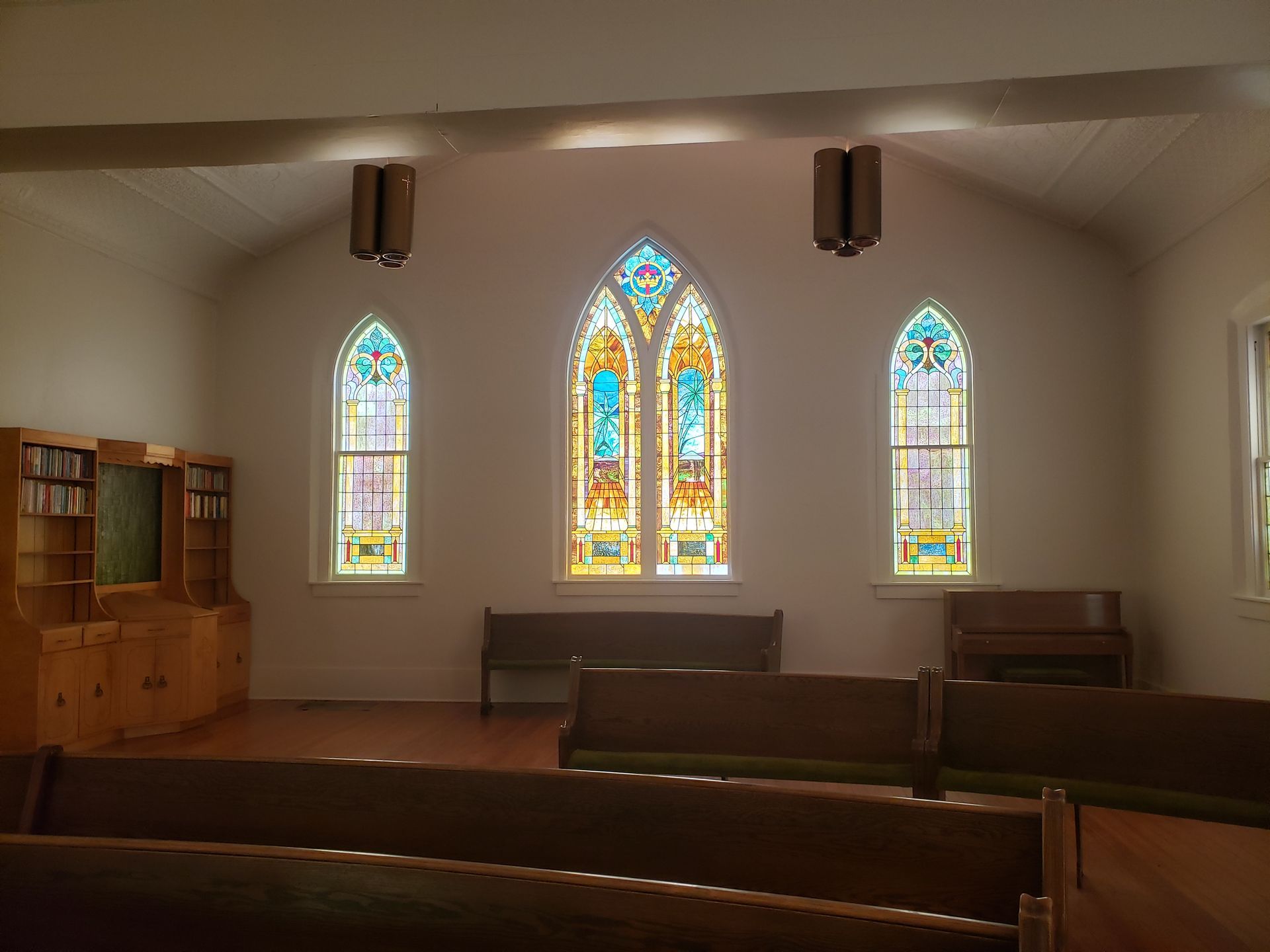 A church with stained glass windows and benches