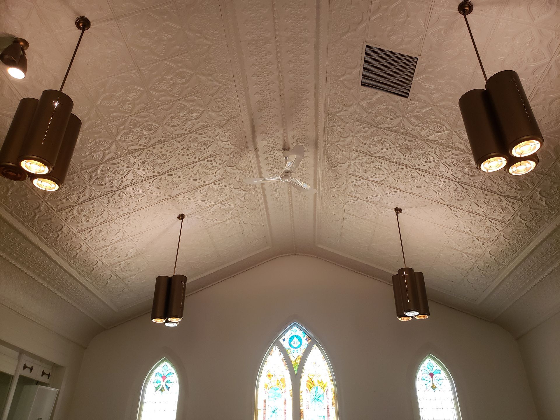 A church with a vaulted ceiling and stained glass windows