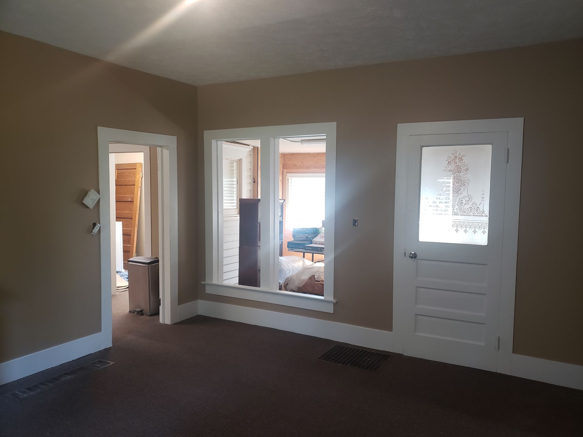 An empty room with a lot of windows and doors